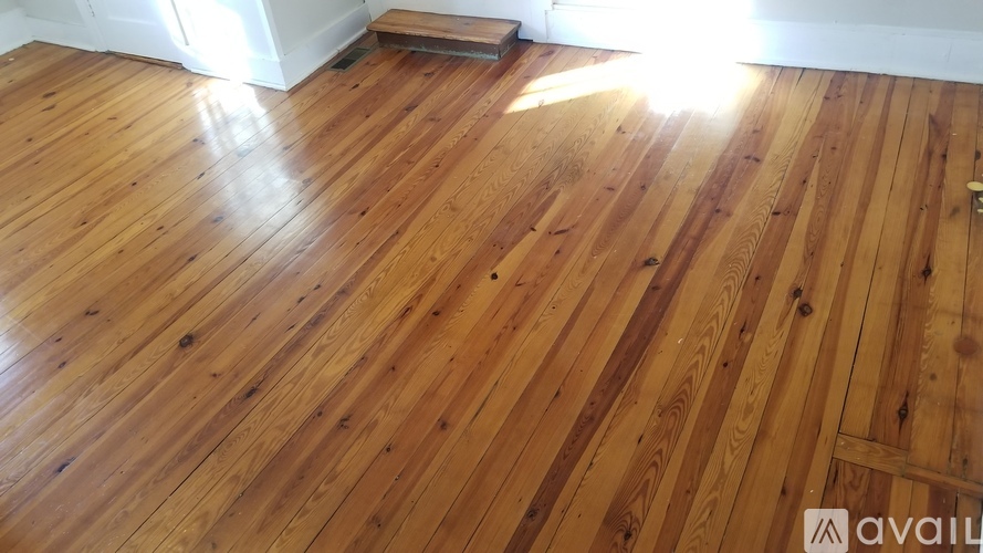 A wooden floor with sunlight shining on it.