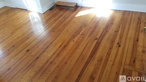A wooden floor with sunlight shining on it.