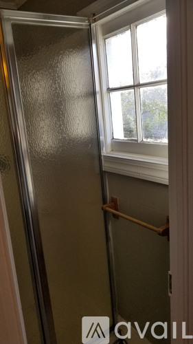 A metal door with a window on the other side.