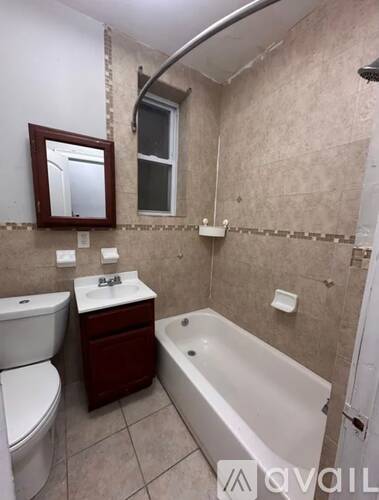 A bathroom with a toilet, sink, and bathtub.