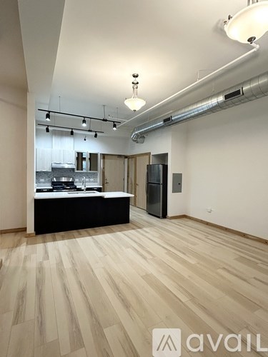 A kitchen area with a refrigerator, sink, and stove.