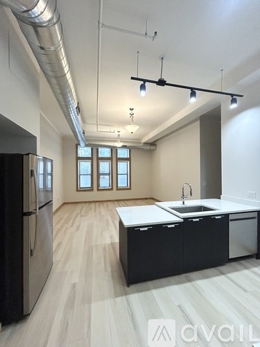 A kitchen with a sink and a refrigerator.