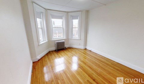 A room with wooden floors and white walls.