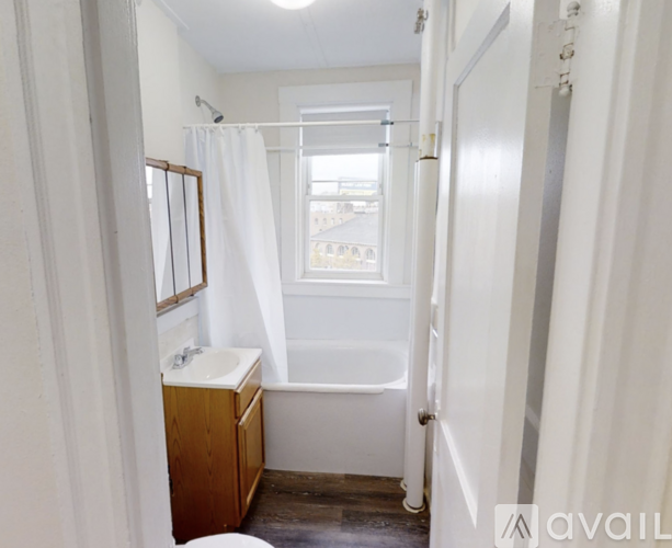 A bathroom with a toilet, sink, and bathtub.