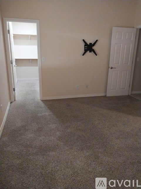 A room with a carpeted floor and a starfish decoration on the wall.