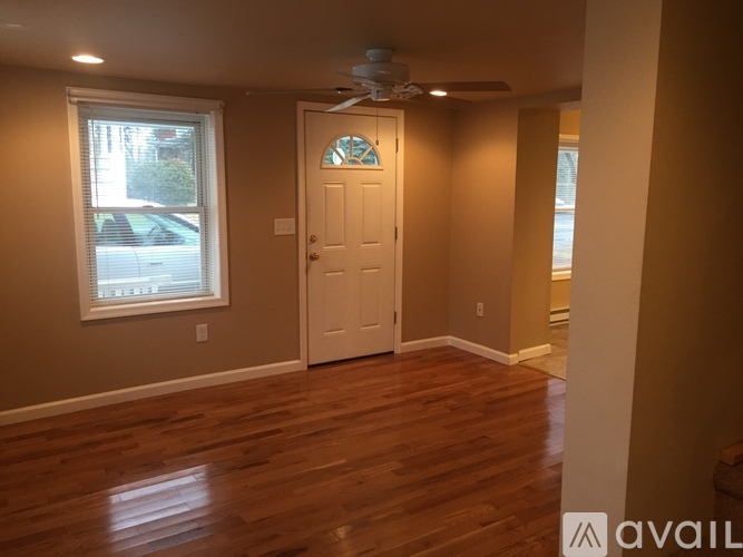 A room with a white door and a window with blinds.