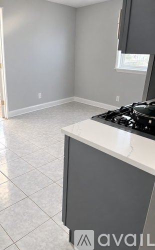 A kitchen with a stove top oven and a window.
