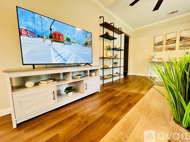 A modern living room with a flat screen TV mounted on the wall.