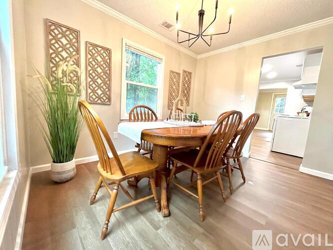 A dining room with a wooden table and chairs.