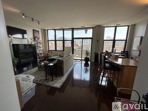 A living room with a flat screen TV and a bar area.