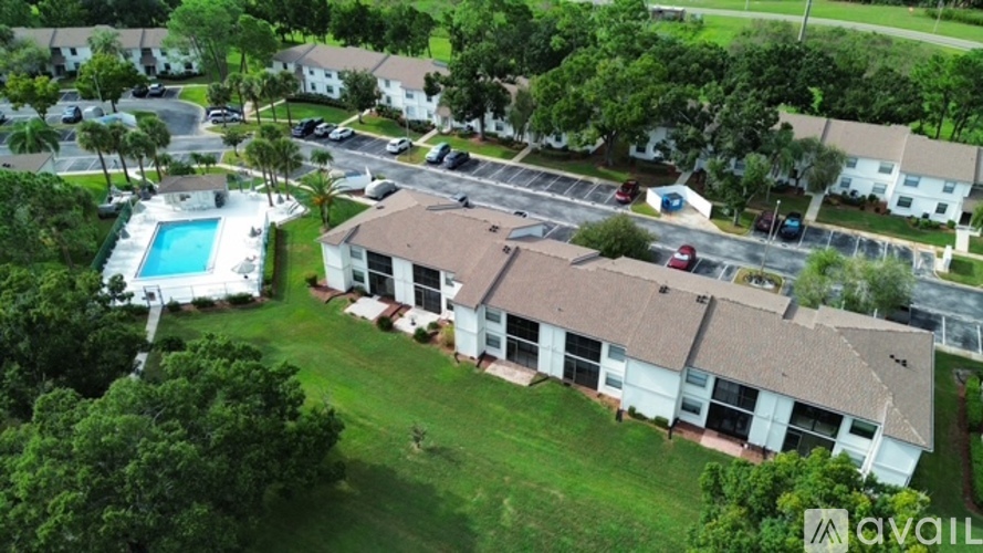 A bird's eye view of a residential area with houses and a swimming pool.