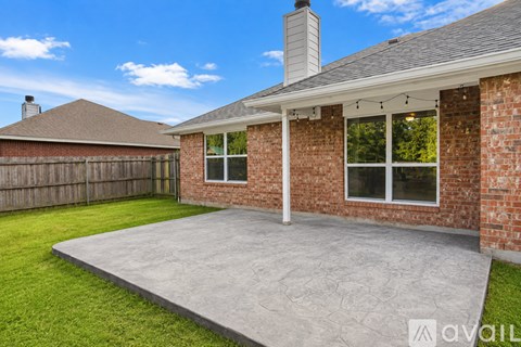 A house with a brick exterior and a grey roof.