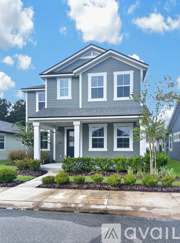 A house with a front yard and a driveway.