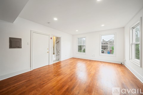 A room with wooden floors and white walls.