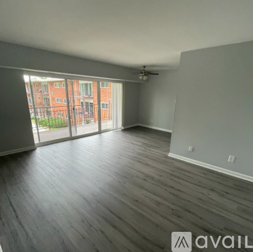 A room with wooden flooring and a ceiling fan.