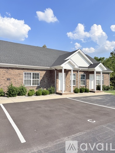 A building with a parking lot in front of it.