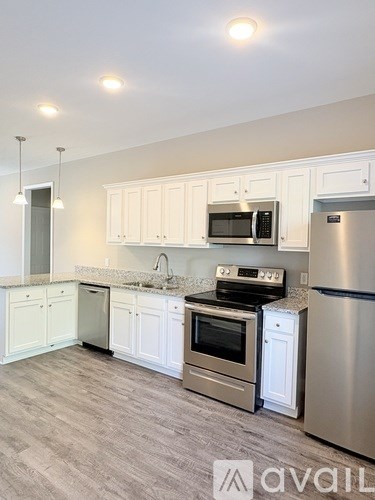 A kitchen with white cabinets and stainless steel appliances.