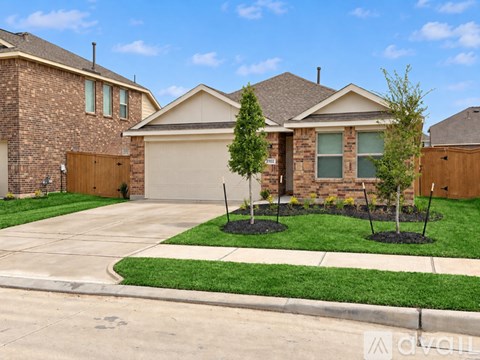 A house with a brown brick wall and a brown garage door.