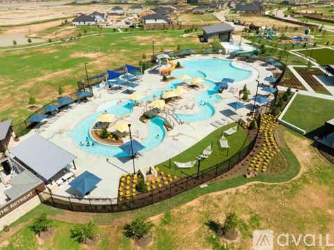 An aerial view of a water park with a large pool and water slides.