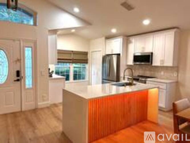 A kitchen with a white counter and a refrigerator.