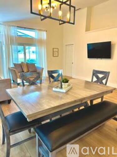 A dining room with a wooden table and chairs.