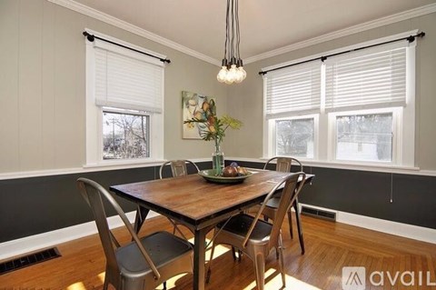 A dining room with a wooden table and chairs.