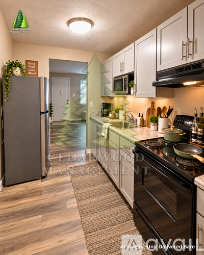 A kitchen with a refrigerator, stove, and cabinets.
