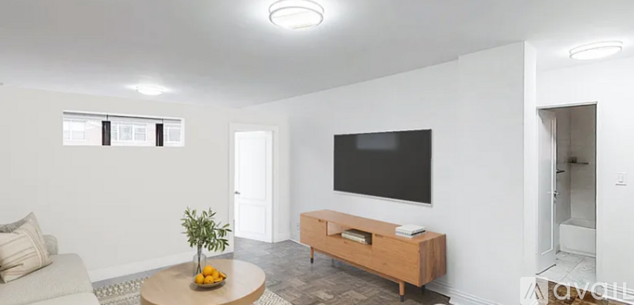 A living room with a flat screen TV mounted on the wall.
