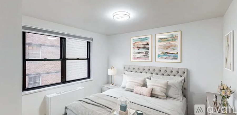 A bedroom with a large bed and a window.