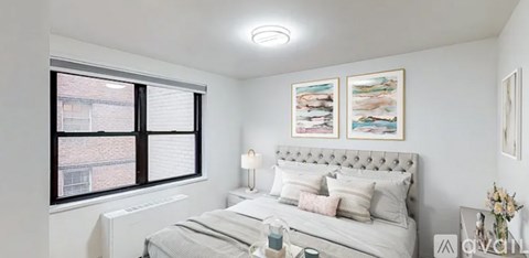 A bedroom with a large bed and a window.