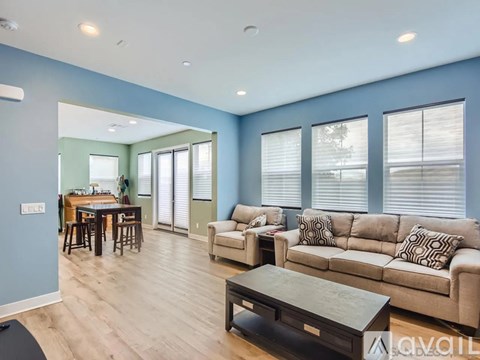 A living room with a dining table and chairs.