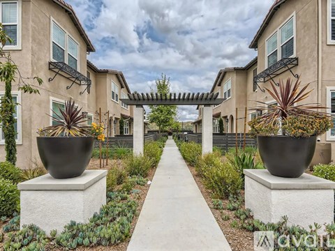 A row of houses with a walkway in the middle.