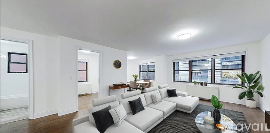 A living room with a white couch and a coffee table.