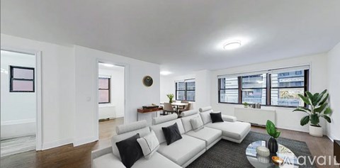 A living room with a white couch and a coffee table.