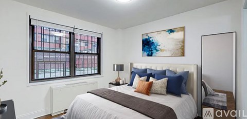 A bedroom with a large bed and a painting on the wall.