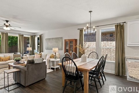 A living room with a dining table and chairs.