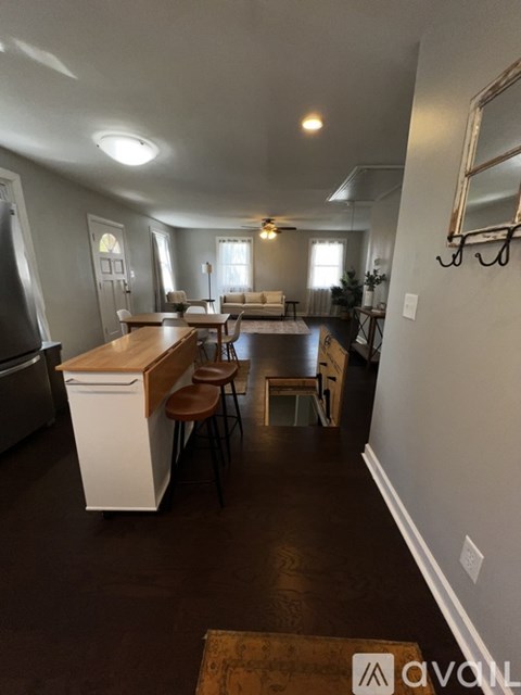 A kitchen with a white dishwasher and wooden countertops.