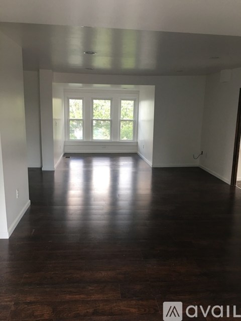 A room with wooden floors and a window.