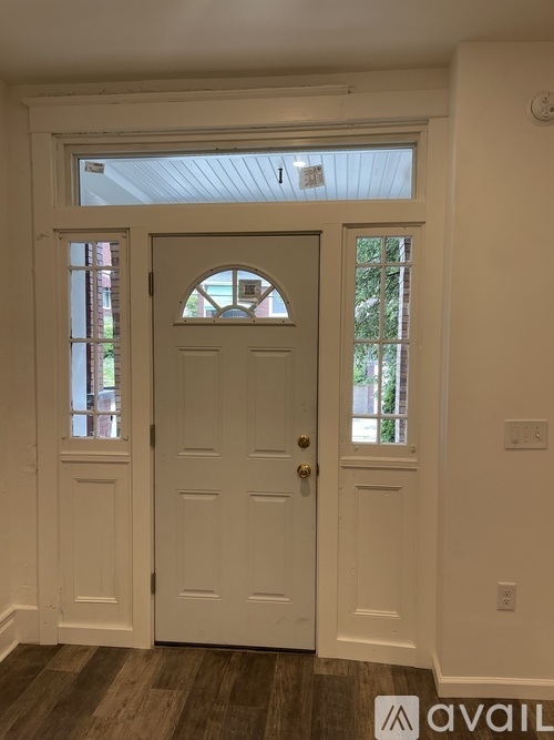 A white door with a window above it.