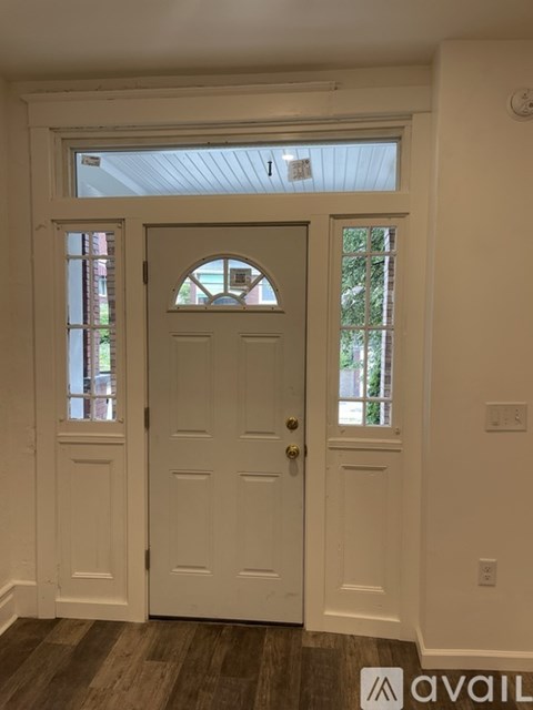 A white door with a window above it.