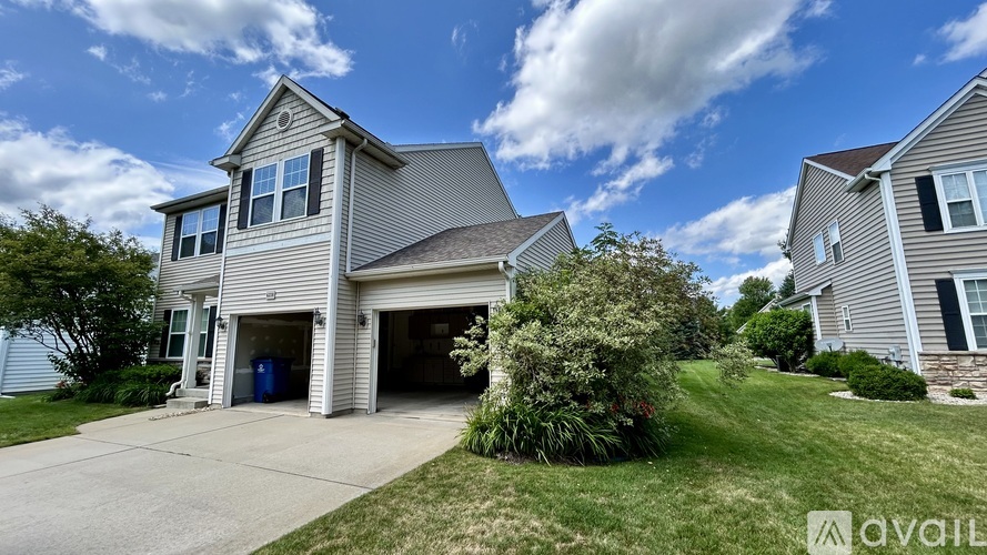 A two-story house with a garage is for sale.