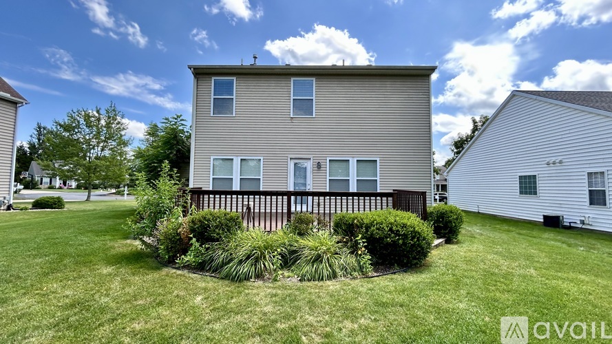 A house with a lawn and a sign that says "available".