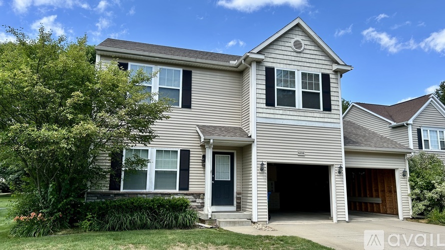 A two-story house with a garage is for sale.