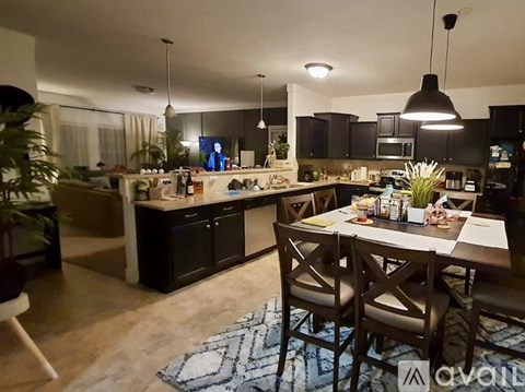 A kitchen with a table and chairs in the middle of the room.