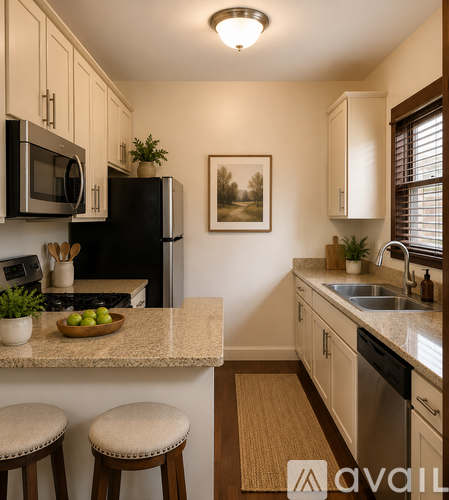 A kitchen with a granite countertop and stainless steel appliances.