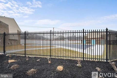 A black metal fence in front of a building.