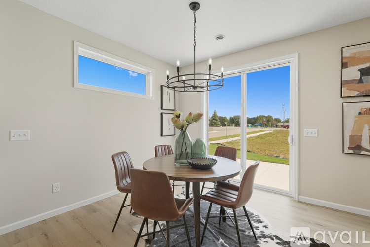 A dining room with a table set for four.