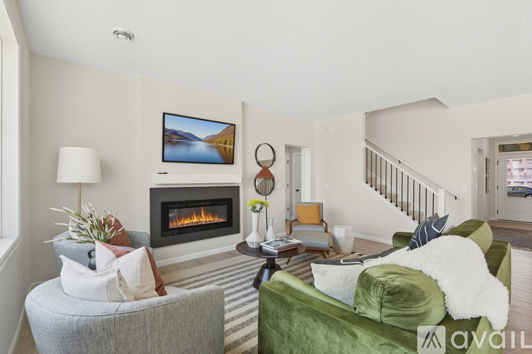 A living room with a fireplace and a painting on the wall.