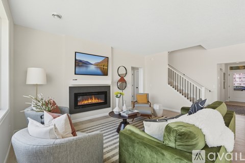 A living room with a fireplace and a painting on the wall.