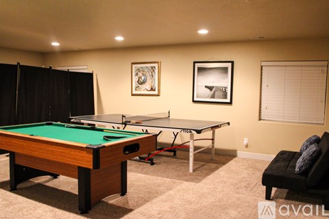 A pool table in a room with a picture frame on the wall.